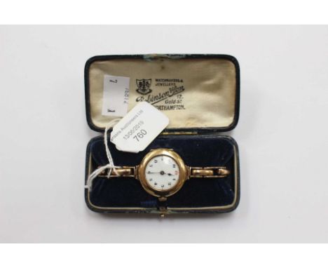 A 9ct gold cased ladies expandable wristwatch, round white enamel dial, numbers, with a yellow metal strap complete with Robi
