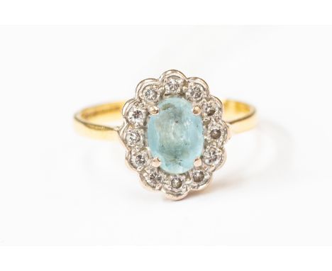 A blue zircon and diamond ring, central oval aquamarine with a diamond set surround,  and 18ct gold, size L, total gross weig
