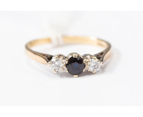 A 9ct gold diamond and sapphire three-stone ring, round cut sapphire to the centre with diamonds set either with a total weig