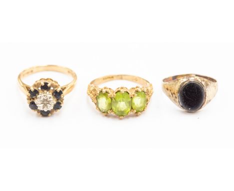 A collection of 9ct gold jewellery comprising 9ct gold three stone peridot dress ring, a 9ct gold cluster dress ring and a si