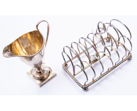 A George III silver seven bar toast rack, segmented arcading, gadroon border and squat ball feet, makers mark probably T and 