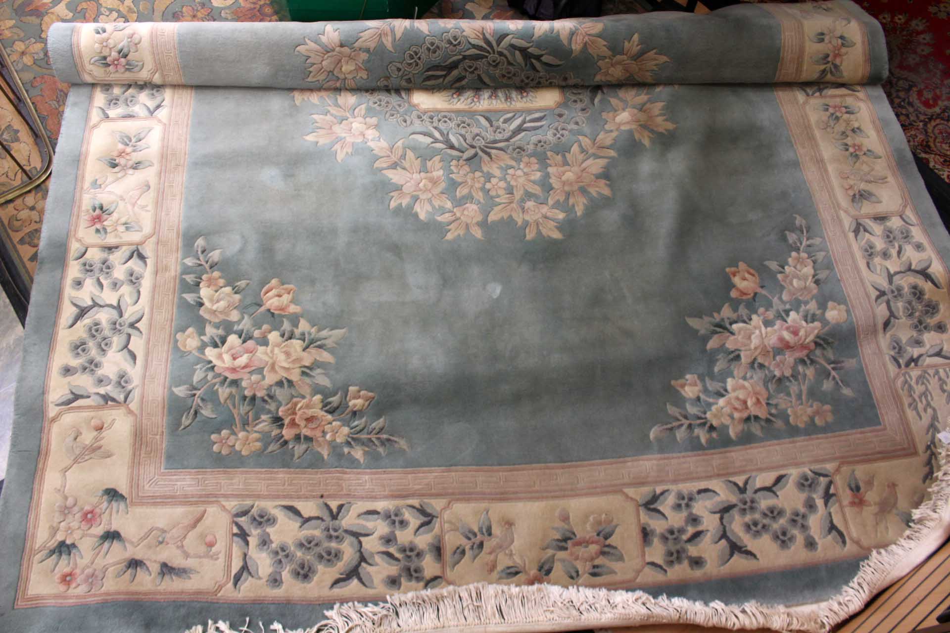 A large Chinese carpet, pale green ground with traditional floral