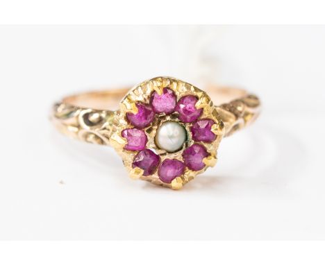 A 19th Century yellow metal ring, set with seed pearl and rubies, size N1/2, total gross weight approx 2.9 gms