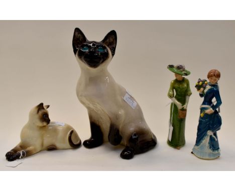 Winstanley cat, Beswick cat and two Goebel lady figurines 