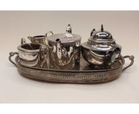 A late Victorian silver plated three piece part tea set having engraved Classical decoration, a further silver plated teapot 