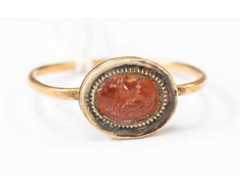 Roman (1st to 4th Century) Gold ring with an orange stone intaglio engraved with Pegasus. Ring size V and a half. Total weigh