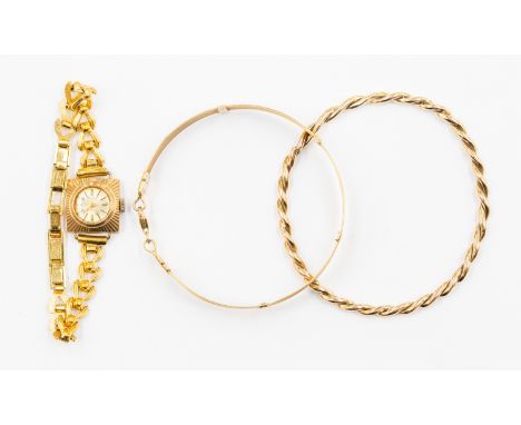A 9k yellow gold woven bracelet approx 7 gms, together with a yellow precious metal twist bangle, approx 14 gms, and a gold c