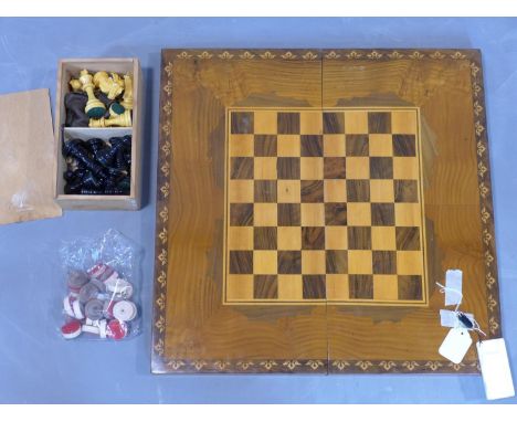 A marquetry inlaid walnut backgammon board, with chess board to top, having counters, H.8 W.55 D.27cm, together with a set of