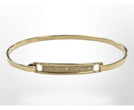 A yellow gold bangle set with diamonds, approx 6cm diameter, 9.6g.