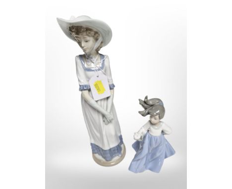 A Nao figure of a lady and a further figure of a girl.
