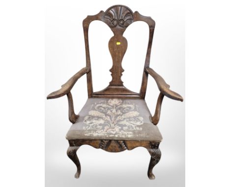 A 19th century carved oak armchair with tapestry seat 