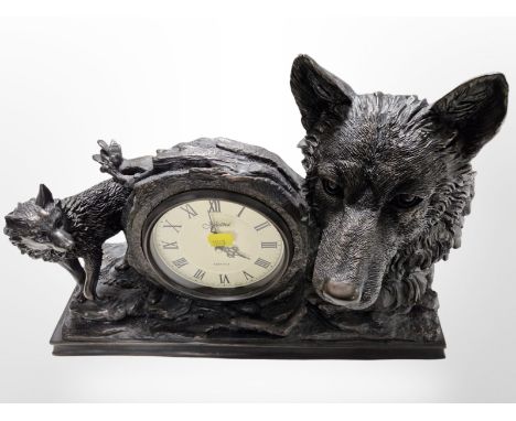 A Juliana bronze-effect quartz mantel timepiece surmounted by wolves, width 43cm.