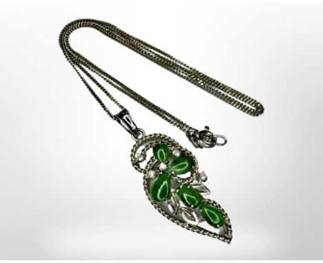 A 9ct white gold jade and diamond pendant on 14ct gold chain. CONDITION REPORT: Pendant length including bale 35 mm. Pendant 