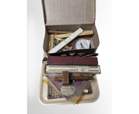 A group of slide rules, hydrometer, protractors, vintage paper guillotine, etc.