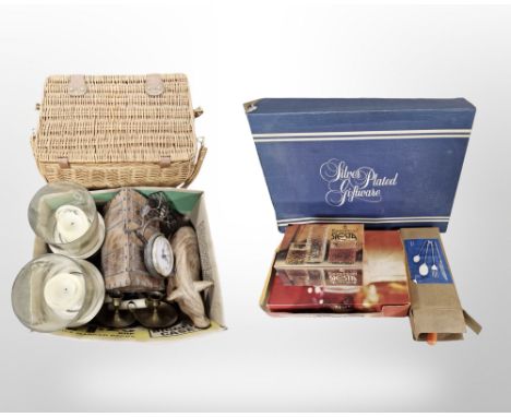 A Wicker hamper, pair of brass candle stands, boxed cutlery and Ravenhead drinking glasses, box of silver-plated gift wares, 