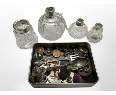 A tin containing badges, pins and hardstone pendants including jade and bloodstone, together with four silver-mounted bottles
