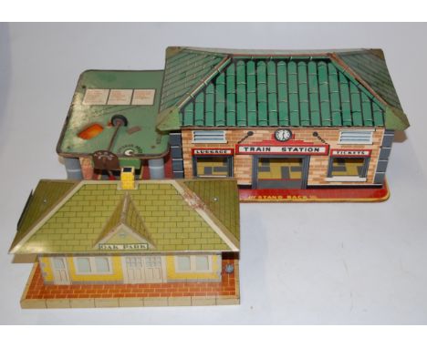 A box containing a quantity of Louis Marx tinplate buildings and accessories, to include tinplate Central Station