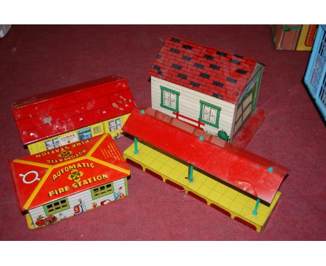Two boxes containing a quantity of Marx and other tinplate buildings and accessories, to include fire station, express tradin