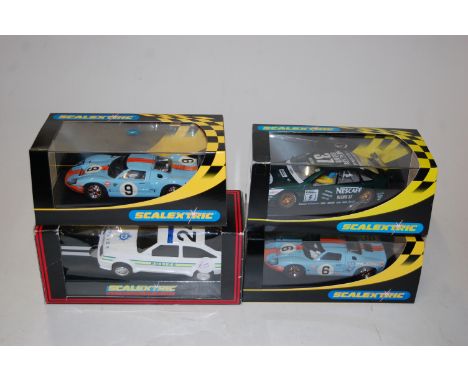 Four various boxed Scalextric slot cars, to include a Ford GT 1968, No.C137 police car, and a C2145 Renault Laguna