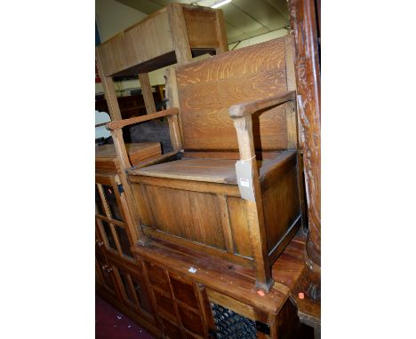 An early 20th century panelled oak fold over monks bench having typical hinged box seat base, width 76.5cm