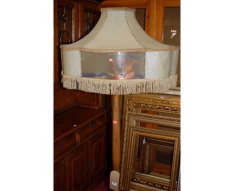 A 1930s turned beech standard lamp, with shaped shade