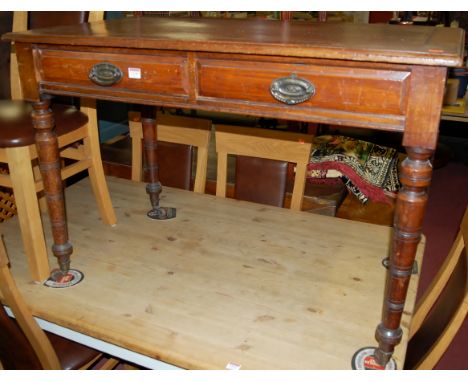 An Edwardian walnut and gilt tooled tan leather inset two drawer writing table raised on ring turned tapering supports, width