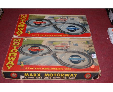 Two boxed Louis Marx motorway playsets, both with two fast long running plastic clockwork cars 