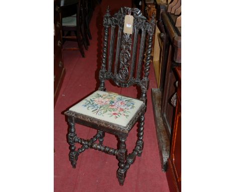 A circa 1900 Caroleon style carved and ebonised oak barleytwist single dining chair, having a floral tapestry upholstered dro