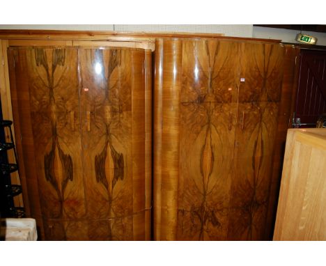 An Art Deco figured walnut cloud-form bedroom suite, comprising large double door wardrobe, w.123cm, double door compactum wi