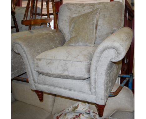 A pair of contemporary Parker Knoll upholstered armchairs, each having cushioned back and seats, and raised on ring turned ta