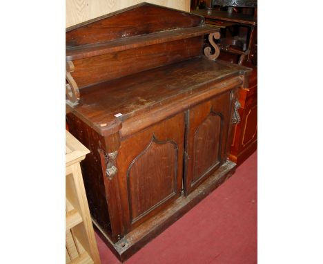 An early Victorian rosewood chiffonier, with raised single shelf superstructure over cushion frieze drawers, to twin lancet a