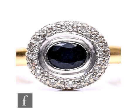An 18ct hallmarked sapphire and diamond oval cluster ring, collar set sapphire within a diamond surround, weight 4.8g, ring s
