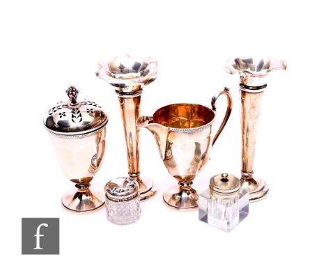 A 1920s silver strawberry set to comprise pedestal cream jug, height 10cm, together with conforming sugar castor with pierced