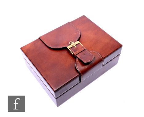A tan leather rectangular Rolex box with brass buckle to front.
