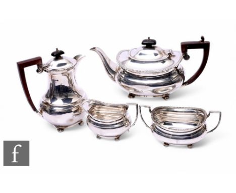 A hallmarked silver three piece, boat shaped tea set with gadroon detail to borders, total weight 35oz, each raised on four b