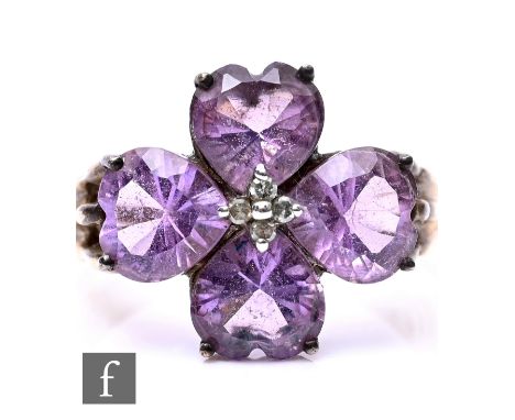 A 9ct hallmarked amethyst and diamond cluster ring, four central diamonds within four heart shaped amethysts, weight 4g, ring