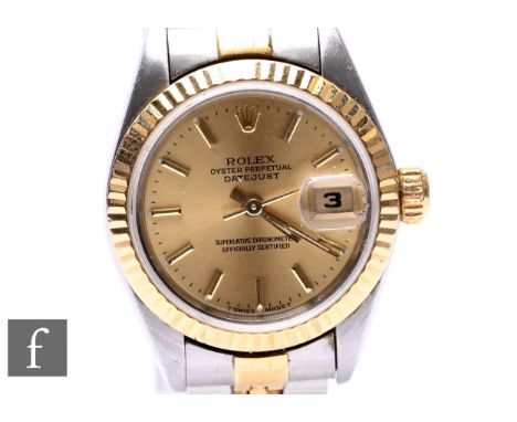 A lady's Rolex Oyster Perpetual DateJust gold and stainless steel wristwatch, model no. 69173, with batons to a champagne dia