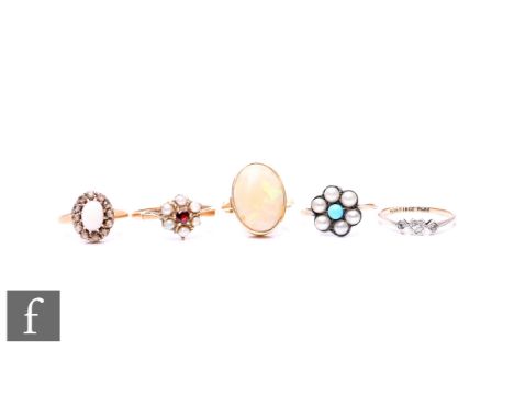 Three 9ct stone set rings to include two opal examples, total weight 7g, with an 18ct three stone diamond ring, weight 1.5g, 