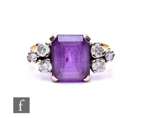 An 18ct amethyst and diamond ring, central square cut amethyst flanked by three diamond to each shoulder, weight 4g, ring siz