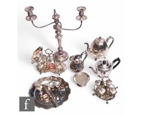 A parcel lot of assorted silver plated items to include a candelabra, teapot, salver, egg cruet, flatware etc.
