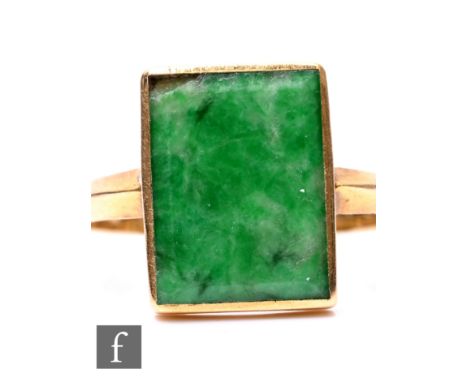 A Chinese high carat single stone jade ring, rectangular collar set stone with plain shoulders, weight 4g, ring size R 1/2, d