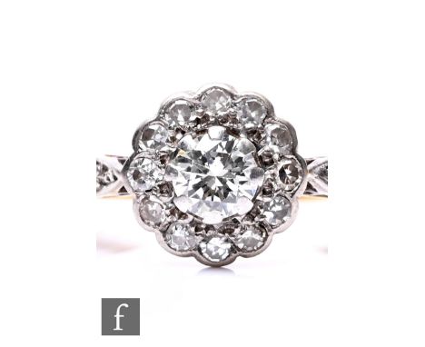 An early 20th Century 18ct diamond daisy cluster ring, weight 3g, ring size K, with diamond set shoulders.