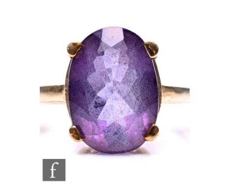 A 9ct gold amethyst set ring, the oval cut amethyst 14xm x 10mm in size, to a yellow gold shank, stamped .375, ring size N 1/