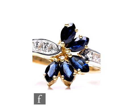 An 18ct hallmarked modern sapphire and diamond ring, five central marquise cut sapphires to diamond set shoulders, weight 3.4