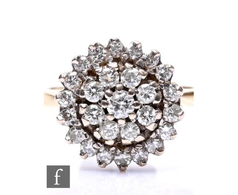 An 18ct hallmarked diamond cluster target ring comprising twenty five individually set stones, diameter of head 14mm, weight 
