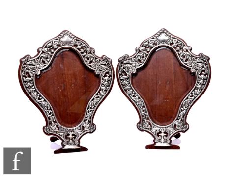 A pair of Victorian hallmarked silver photograph frames, the cartouche shape with a border of pierced bell flowers, shells an