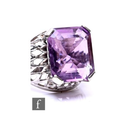 A 14ct white gold single stone amethyst ring, emerald cut, claw set stone to a pierced basket head and shoulders, weight 0.5g