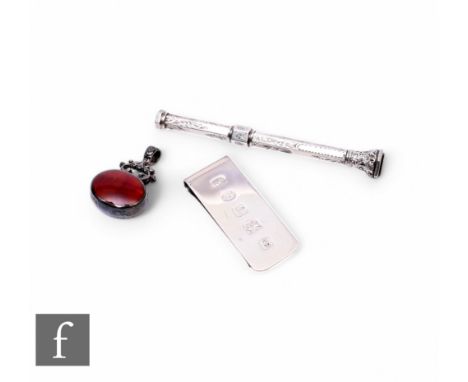 Three silver items to include a modern money clip and fob with an earlier slide pencil. (3)