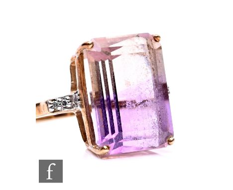 A 9ct hallmarked amethyst and diamond ring, emerald cut amethyst with diamond set shoulders, weight 3.5g, ring size N.