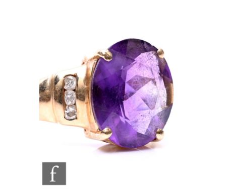 A 14ct amethyst and diamond ring, oval amethyst with three diamond set channel set to one shoulder, weight 4.3g, ring size O.